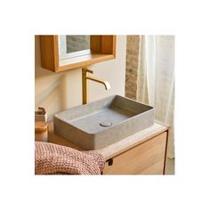 a bathroom sink sitting on top of a wooden counter next to a mirror and window