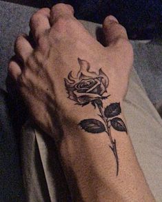 a person's foot with a rose tattoo on it