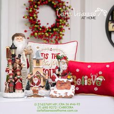 a christmas scene with santa claus and other holiday decorations on a table in front of a wreath