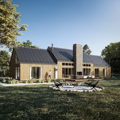 a house with a large lawn in front of it and two chairs on the grass