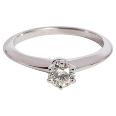 Tiffany & Co. Diamond Solitaire Ring in 950 Platinum I VVS1 0.31 CTW PRIMARY DETAILS SKU: 123649 Listing Title: Tiffany & Co. Diamond Solitaire Ring in 950 Platinum I VVS1 0.31 CTW Condition Description: Retails for 2750 USD. In excellent condition and recently polished. Ring size is 4.25. Comes with Box, Appraisal and Tiffany Diamond Certificate. Brand: Tiffany & Co. Metal Type: Platinum Metal Purity: 950 Ring Size: 4.25 Pre-Owned Jewelry Condition: Excellent CENTER STONE INFORMATION Center Stone 1 Type: Diamond Center Stone Weight 1 (cts): 0.31 Center Stone 1 Shape: Round Center Stone 1 Color: I Center Stone 1 Clarity: VVS1 Center Stone 1 Cert Type: Tiffany Certificate Center Stone Cert Number 1: G05020138 SIDE STONE INFORMATION Original Box?: Yes Original Papers?: Yes Tiffany And Co Diamond, Tiffany Diamond, Contemporary Engagement Rings, Platinum Diamond Engagement Rings, Platinum Diamond Rings, Diamond Solitaire Ring, Information Center, Platinum Engagement Rings, Cushion Cut Diamonds