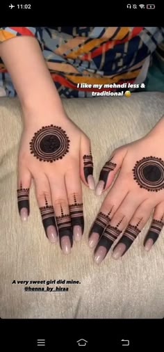 two hands with henna tattoos on them