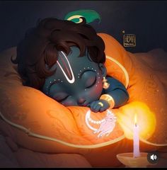 a little boy laying in bed next to a lit candle