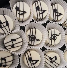 some white and black cupcakes with music notes on them