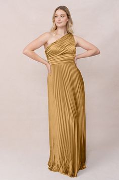 Model: Sydney; Size: 10; Color: Gold Pre-draped One Shoulder Dress For Prom, One Shoulder Maxi Dress With Fitted Bodice For Gala, One Shoulder Dress With Ruched Fitted Bodice, Pre-draped Bridesmaid Dress With Asymmetrical Neckline, Fitted One Shoulder Dress With Pleated Bodice For Gala, One Shoulder Dress With Ruched Bodice For Gala, Strapless Dress With Asymmetrical Neckline For Gala, Gala One-shoulder Dress With Pleated Bodice And Asymmetrical Neckline, Formal One-shoulder Dress With Pleated Bodice And Asymmetrical Neckline