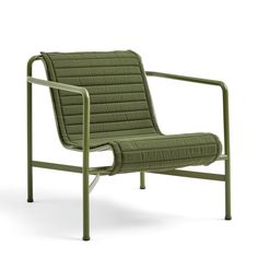 a green chair sitting on top of a white floor next to a metal armrest