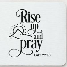 a white mouse pad with the words rise up and pray