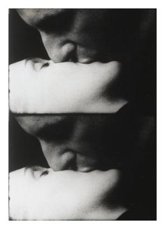 two people with their heads close to each other, one is holding the other's head