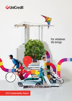 two men riding bikes next to each other in front of a building with colorful letters