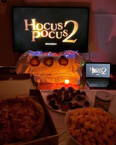 a table topped with lots of food next to a laptop computer on top of a desk