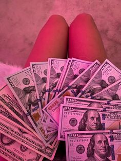 a woman's legs are surrounded by money