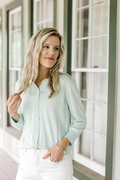 Model wearing a button up mint green cardigan with 3/4 sleeves. Chic Spring Cardigan With Button Cuffs, Green Long Sleeve Cardigan For Spring, Spring Button-up Cardigan For Work, Spring Workwear Button-up Cardigan, Spring Layering Cardigan With Button Closure, Spring Casual Cardigan With Button Cuffs, Chic Spring Cardigan With 3/4 Sleeves, Spring Workwear Cardigan With Button Closure, Casual Spring Button-up Cardigan