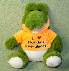 a stuffed frog wearing a shirt that says i love florida's evergladess