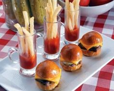 mini burgers and french fries on a white plate with red checkered tablecloth