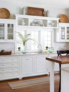 the kitchen is clean and ready for us to use it's white cabinetry