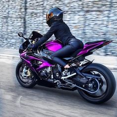 two people riding on the back of motorcycles