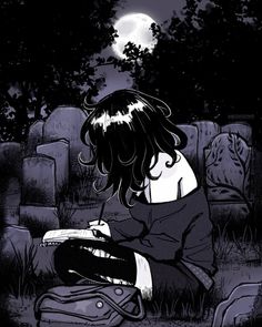 a woman sitting on the ground in front of a cemetery at night with her book open