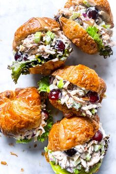 croissants filled with chicken salad and cranberries on top of marble counter