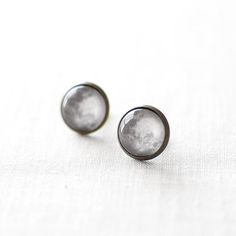 Lovely pair of solar system inspired earrings featuring an image of the full moon. The earrings are made from bronze tone metal and glass domes. These celestial moon studs will make a perfect gift for space lovers.Measurements & Details: • 1/2" in diameter (14mm).• available as studs or drops• These full moon earrings come in a gift box - perfect for gift giving and safekeeping.• Buying these celestial earrings as a gift? Add a handwritten card with a message of your choice.➳ Want to see mor Moon Earrings Silver, Space Earrings, Space Lovers Gifts, Moon Stud Earrings, Earrings Moon, Celestial Earrings, Space Lovers, Moon Studs, Jewellery Uk