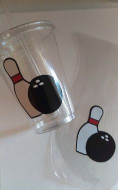 two plastic cups with bowling pins on them