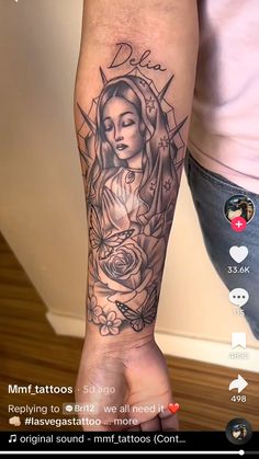 a woman's arm with tattoos on it and an image of the virgin mary