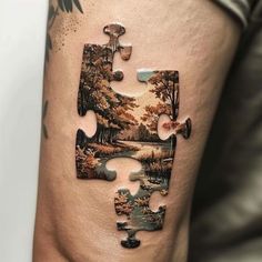 a piece of puzzle sitting on top of a man's thigh with trees and water in the background