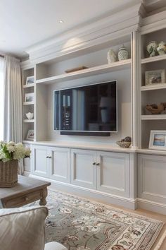 a living room filled with furniture and a flat screen tv on top of a wall