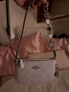 mini coach purse with og coach charm and snowflake charm + heart bag extender - coach purse - coach mini bag - bag extender - white coach bag - trendy - aesthetic - feminine - girly #aesthetic #coach #shoulderbag #purse #minibag Silver Coach Bag, Coach Bags With Charms, Mini Coach Bag, Coach Purse Aesthetic, Coach Bags Aesthetic, Mini Bag Aesthetic, White Coach Bag, Coach Mini Bag, Purse Aesthetic