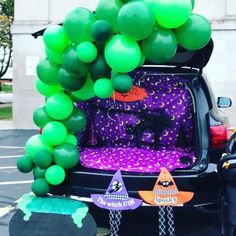 the trunk of a car is decorated with balloons