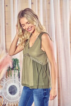 This effortlessly cool tank was made for summer nights that turn into mornings. In an olive green knit blend, it features spaghetti straps, a raw-edge hem and neckline studded with metal embellishments that catch the light. Throw it on over your favorite bralette or camisole and head out for a night of adventure that lasts until dawn. Whether you're dancing on the beach or stargazing with friends, this breezy top moves with you while its loose, laid-back fit keeps you comfortable into the wee ho Green Cotton Camisole With Tank Straps, Trendy Green Tank Top For Layering, Green Tank Top For Spring Layering, Sleeveless Olive Top For Summer, Summer Khaki Tops For Layering, Chic Green Tank Top For Layering, Green Trendy Cotton Camisole, Trendy Green Cotton Camisole, Trendy Khaki Tank Top For Spring