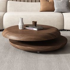 a coffee table sitting on top of a carpeted floor next to a white couch