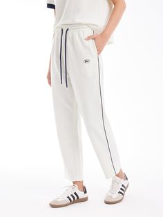 Details: Simple white panelled trousersKnitted towelling textureRelaxed, straight fitSide navy stripes Materials & Care: Cotton 55.5%Lycra 26.2 %Polyester 18.3% Hand wash | Dry clean Do not bleach Size & Fit: Model is 5'7", Bust 32, Waist 24, Hips 35, wearing a size S Item #: SN2PA35 White Athleisure Sweatpants With Contrast Stripes, Athleisure White Bottoms With Straight Hem, Sporty White Bottoms With Straight Hem, Casual White Pants With Contrast Stripes, Sporty White Sweatpants With Side Stripes, Sporty White Bottoms With Side Stripes, White Ankle-length Sporty Sweatpants, White Athleisure Pants With Straight Hem, White Athleisure Bottoms With Contrast Stripes