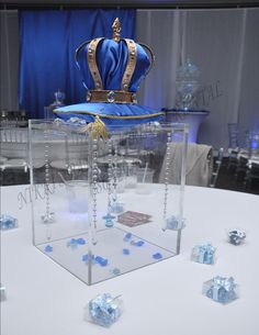 a table topped with lots of blue dice and a large crown on top of it