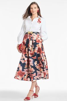 There are few things that are as perennial as the "party" skirt. The tea-length box pleat event skirt can easily be worn 12 months out of the year, especially in this floral print. It can be paired with the coordinating bralette tops or it can easily go back to a crisp with a crisp white blouse or black turtleneck.Details:Model is 5'10" wearing a size 2Full Length 52"35 1/2" Skirt Length100% PolyesterBack ZipperImportedStyle #F241S02-961 Silk Full Skirt With Floral Print, Chic Long Floral Print Pleated Skirt, Spring Formal A-line Pleated Skirt, Chic Long Pleated Skirt With Floral Print, Spring Silk Skirt With Pleated Waist, Chic Floral Print Pleated Skirt For Spring, Spring Pleated Skirt Dress, Floral Print Flared Evening Skirt, Spring Dresses With Pleated Waist