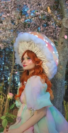 a woman with red hair wearing a white hat and holding a rose in her hand