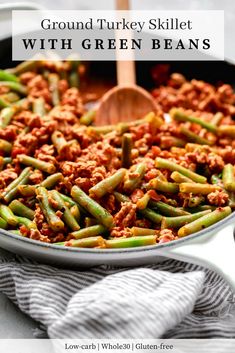 ground turkey skillet with green beans in a pan on a white counter top and text overlay