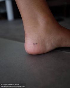 a close up of a person's foot with the word mom written on it