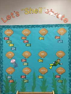 a bulletin board with shells and fish on it