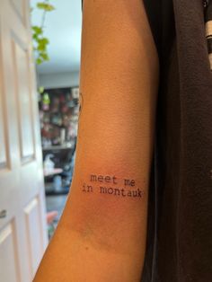 a man with a tattoo on his arm that says meet me in montauk