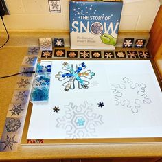 the story of snow is displayed on a table