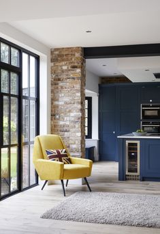 a yellow chair sitting in front of a kitchen