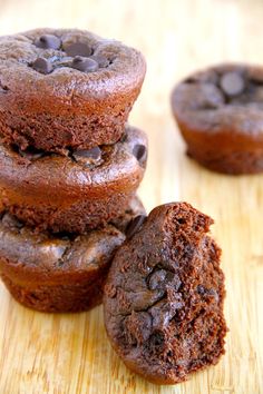 three chocolate muffins stacked on top of each other