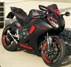 a red and black motorcycle parked on the street