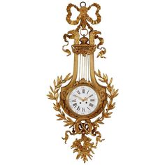 an ornate gold clock hanging on the wall