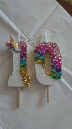 the number 10 is made out of candy and has a unicorn on it's head