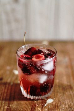 a close up of a drink on a wooden table