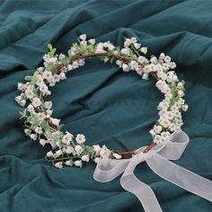 a white flower crown on a green cloth