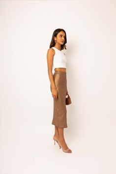 This stunning midi skirt features a rich coffee brown color. Its metallic foil coating adds a touch of glamour, while the high rise and elasticated waist ensure a comfortable fit. Made from soft stretch jersey fabric, it's both stylish and cozy 92% Viscose, 8% Elastane Hand wash White Dresses For Sale, Metallic Trousers, Coffee Brown Color, Brown Maxi Skirts, Metallic Midi Skirt, Knit Loungewear, Metallic Skirt, Coffee Brown, Halterneck Dress