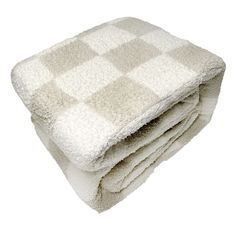 two towels stacked on top of each other in front of a white background with checkered pattern