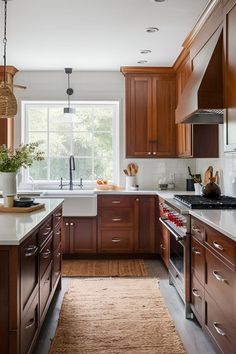 a kitchen with wooden cabinets and white counter tops, along with an area rug on the floor